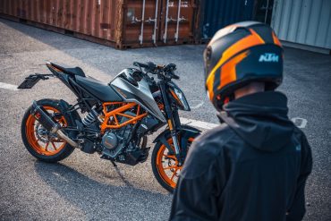 Rider standing near KTM 390 Duke