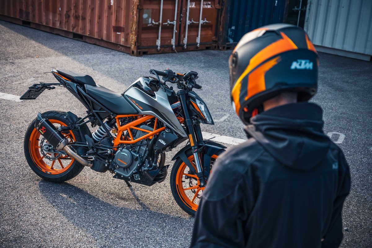Rider standing near KTM 390 Duke
