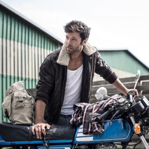 Portrait of man leaning on motorcycle
