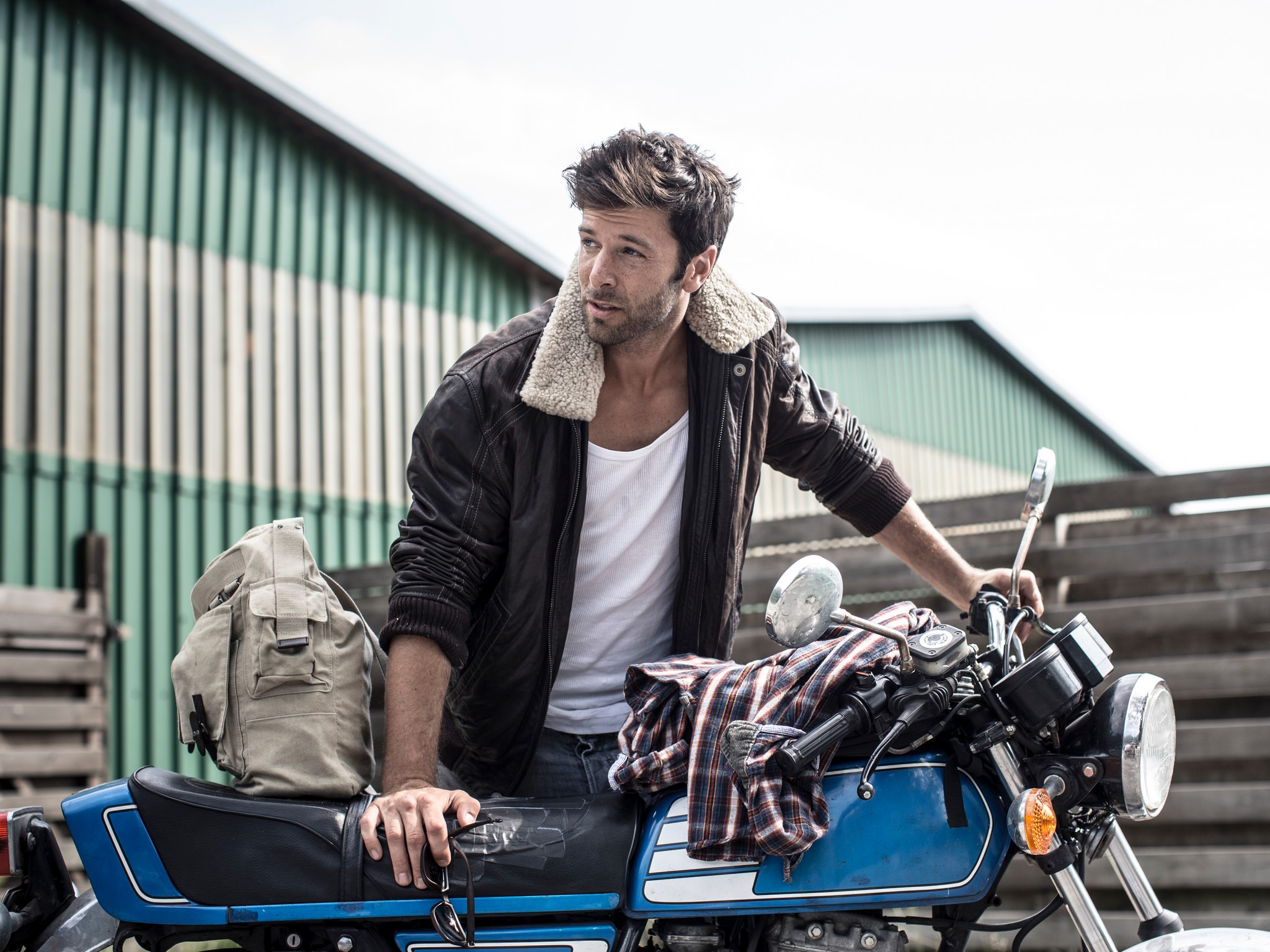 Portrait of man leaning on motorcycle