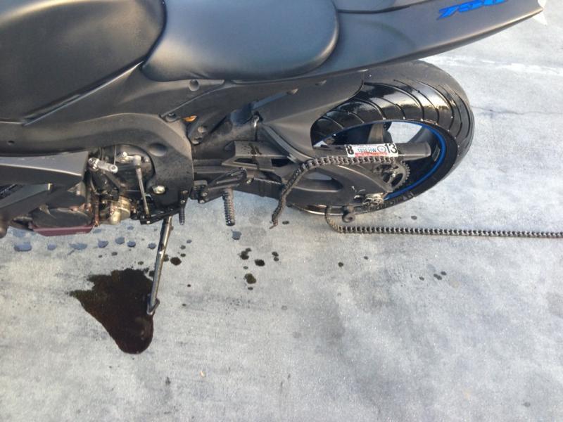 Chain removed from motorcycle on garage floor