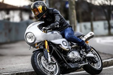 Rider taking corner on motorcycle with custom modifications