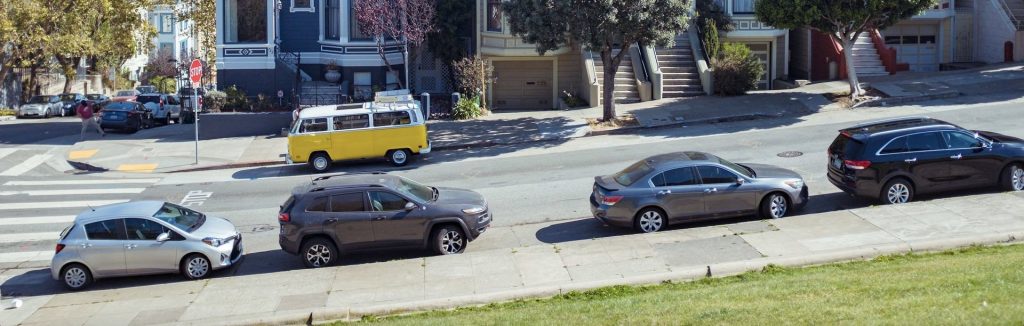 Cars parked on a gentle hill
