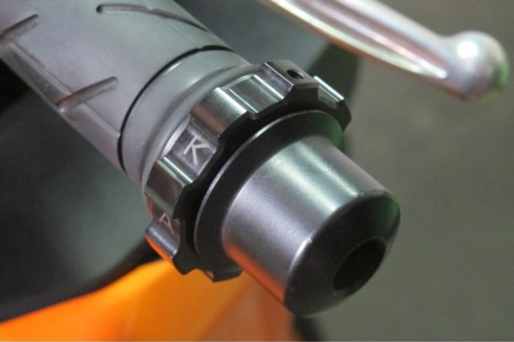 Image of the Kaoko Cruise Control bar end attachment on a motorcycle handlebar.