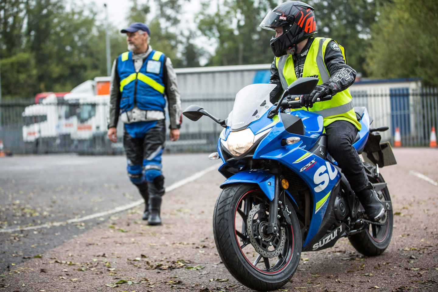 Rider on blue sport bike on side of road