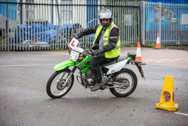 Rider on motorcycle executing u-turn in parking lot