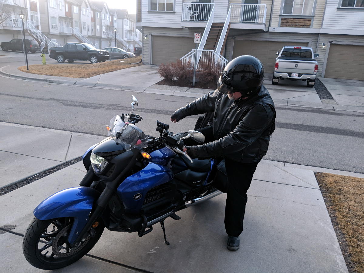 Slide your leg across the seat and grab the front brake