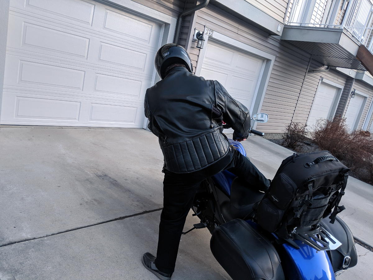 Slide your leg across the seat and grab the front brake