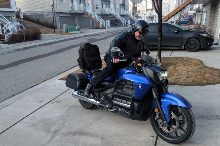 Kick mounting a motorcycle