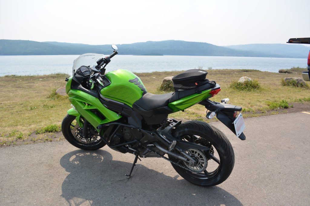 Kawasaki Ninja 650 parked in front of lake in Calgary, Alberta