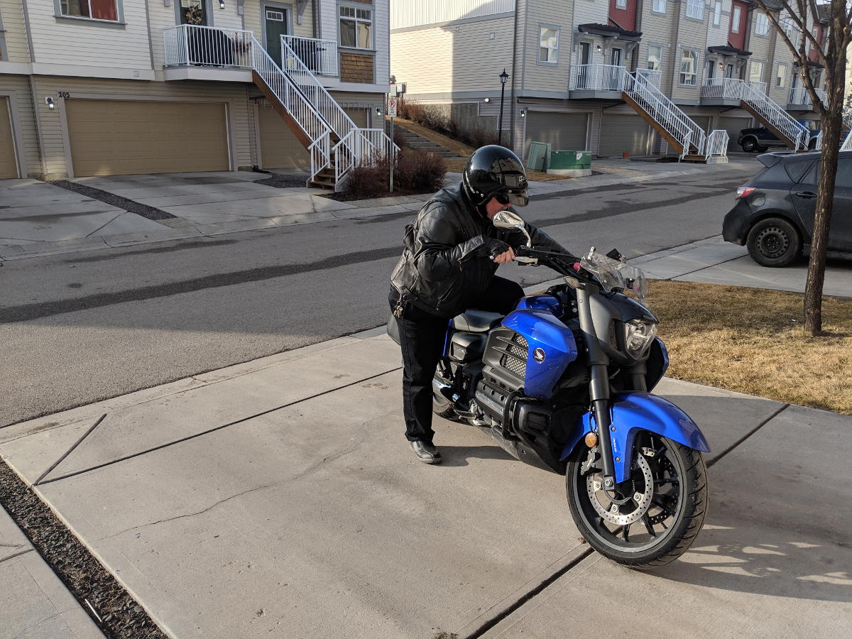 Reverse kick mounting a motorcycle