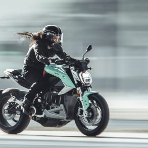 Woman on motorcycle travelling at speed