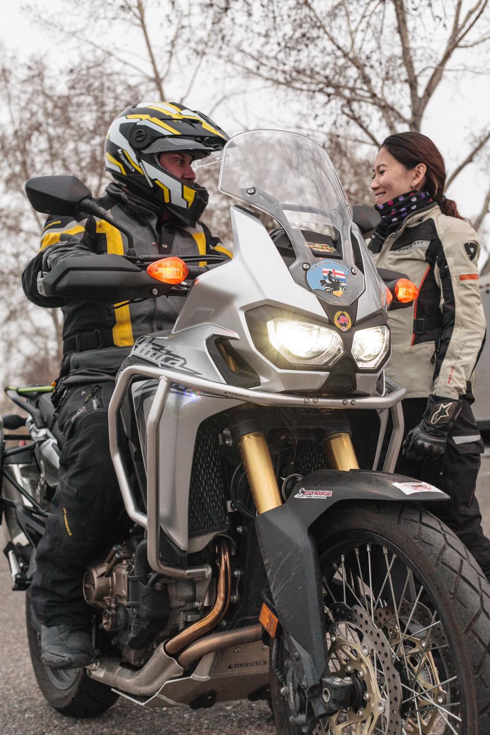 Trevor sitting on a 2016 Honda Africa Twin 1000 DCT and talking to his wife Lanchi